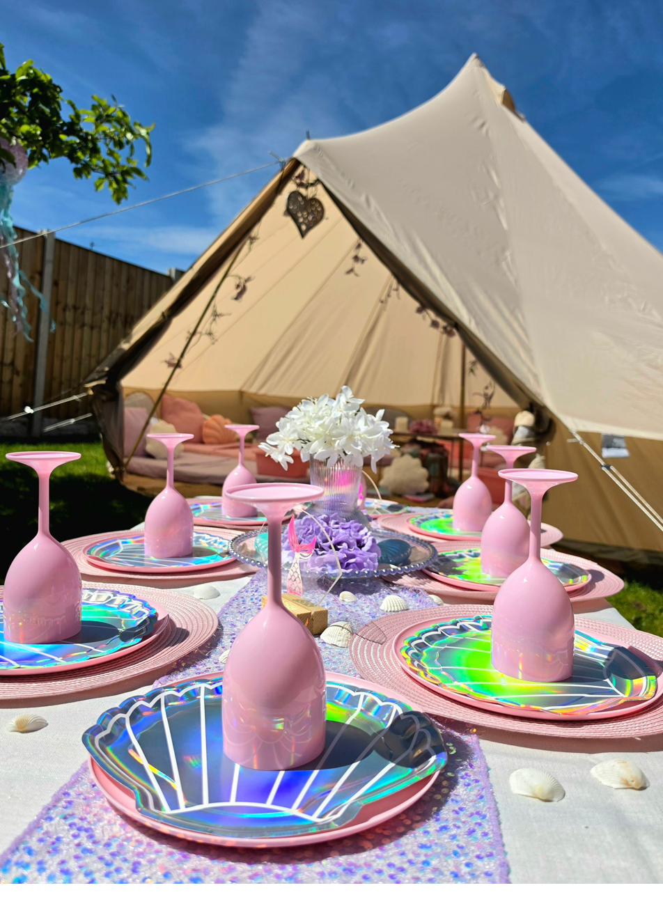 Close-up of a mermaid themed party table with iridescent tableware