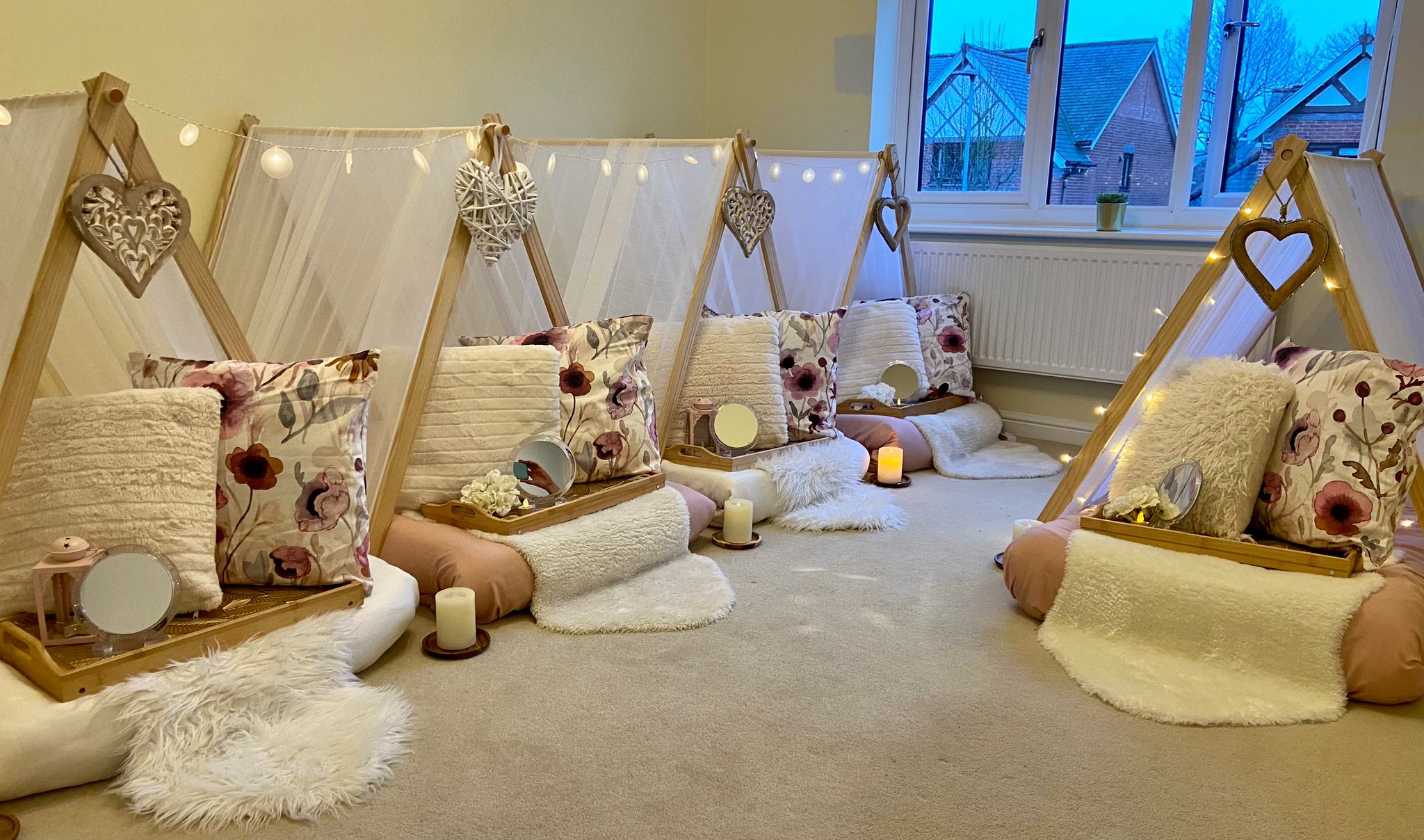 Floral heart and fairy light styled teepees for a magical children's sleepover party