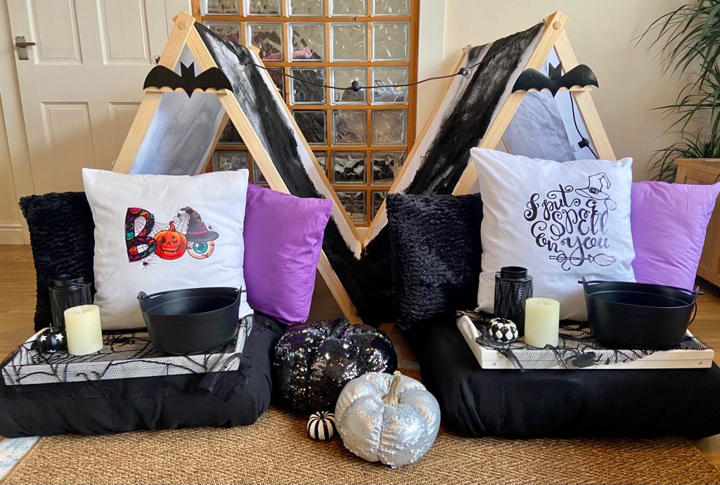 Halloween themed teepees decorated with black bats for a spooky children's sleepover party